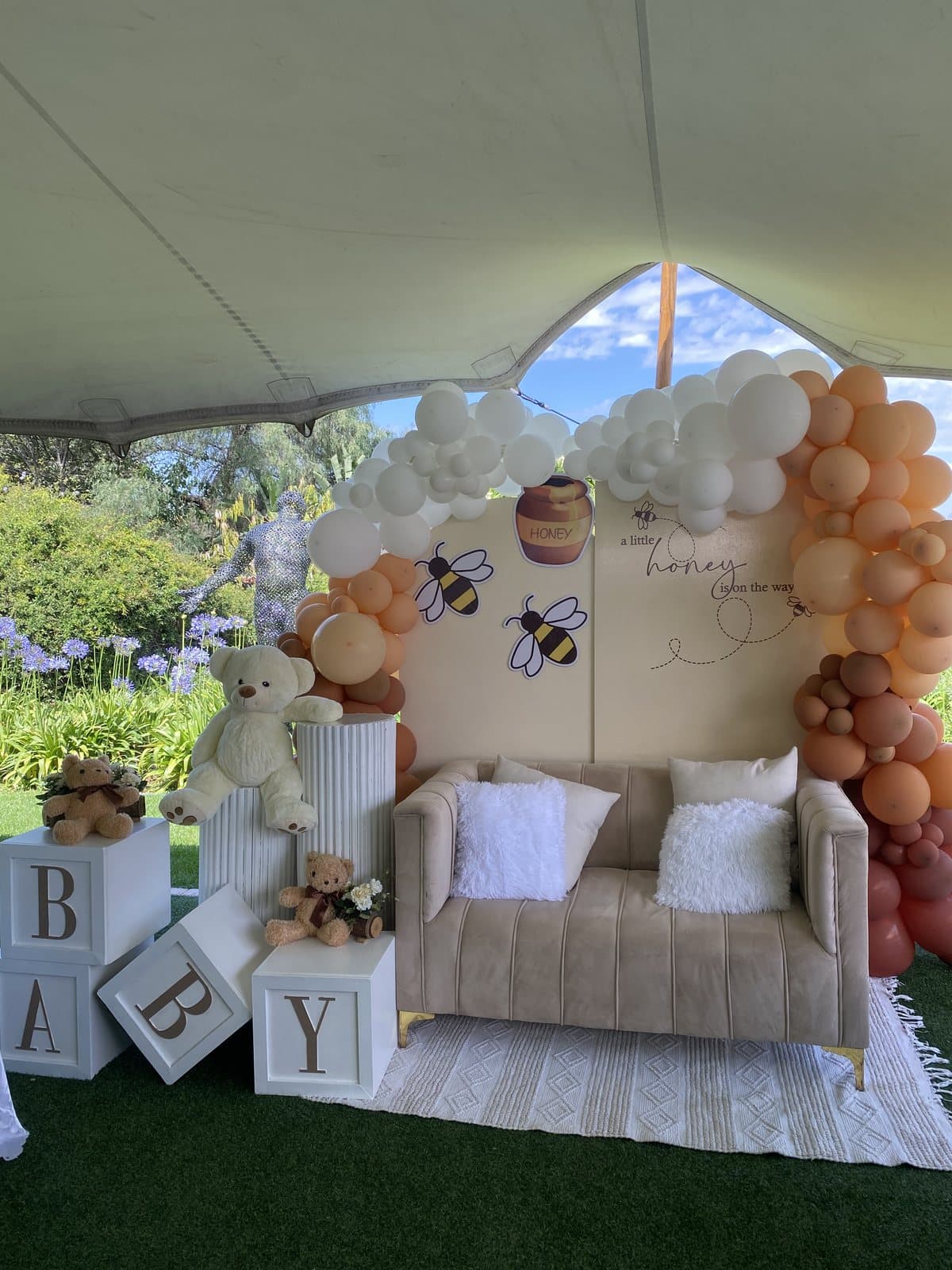 Tan and white balloon arch with wooden BABY blocks for a baby shower