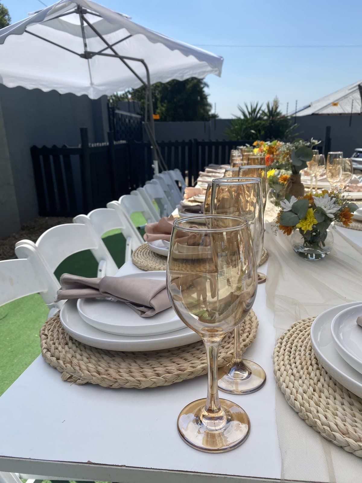 Elegant gold-rimmed table setting with champagne glasses