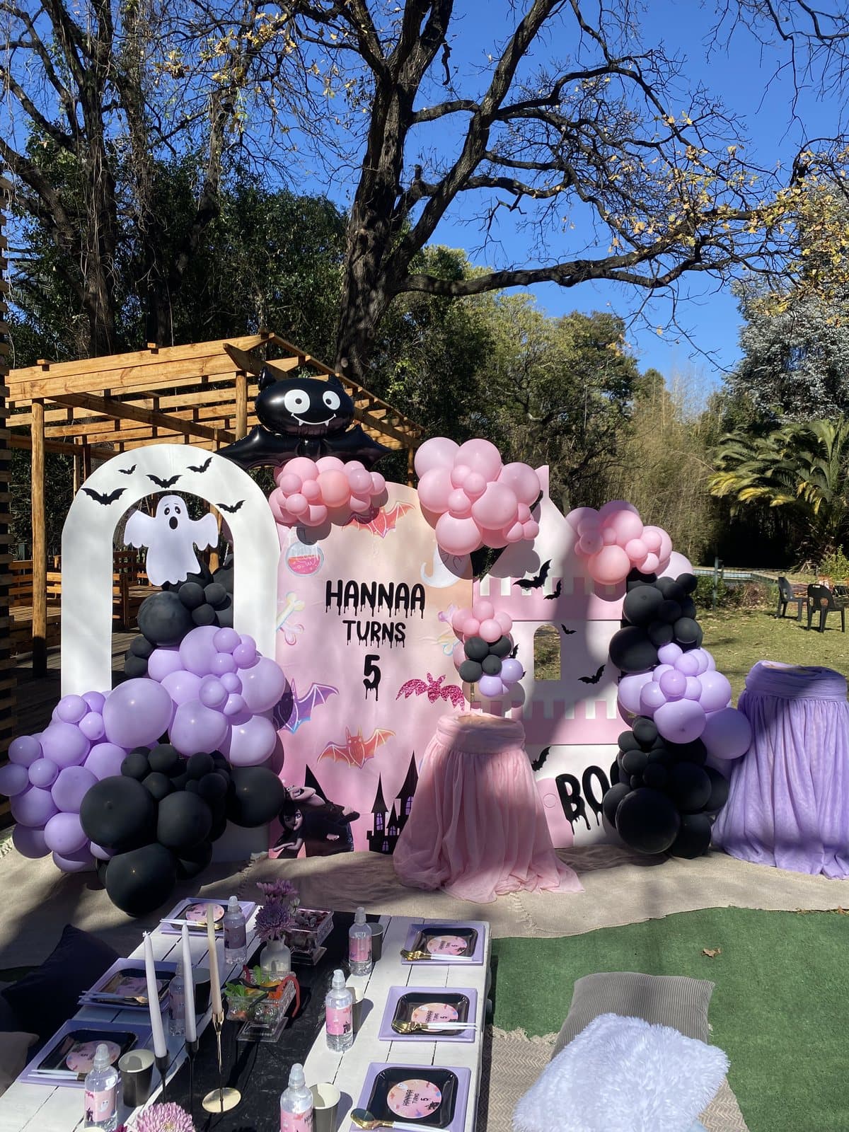Pastel balloon arch and styled table for a fifth birthday party